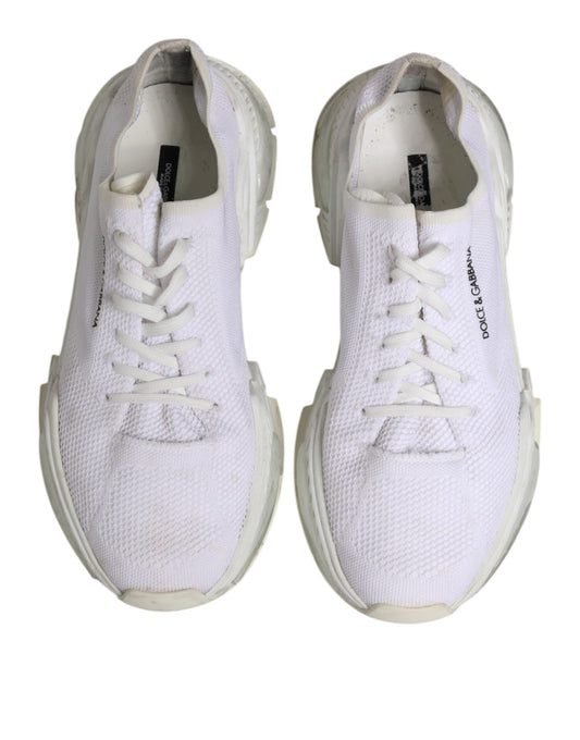 Pair of white sneakers with laces, branded logo on side and tongue