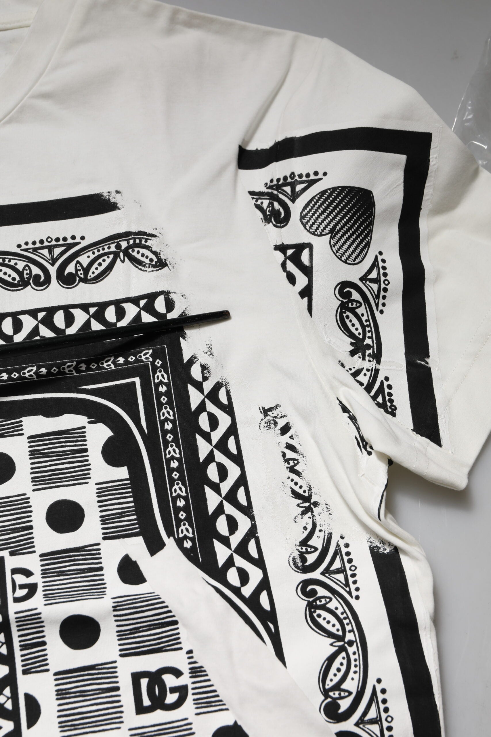 White t-shirt with black tribal design on front