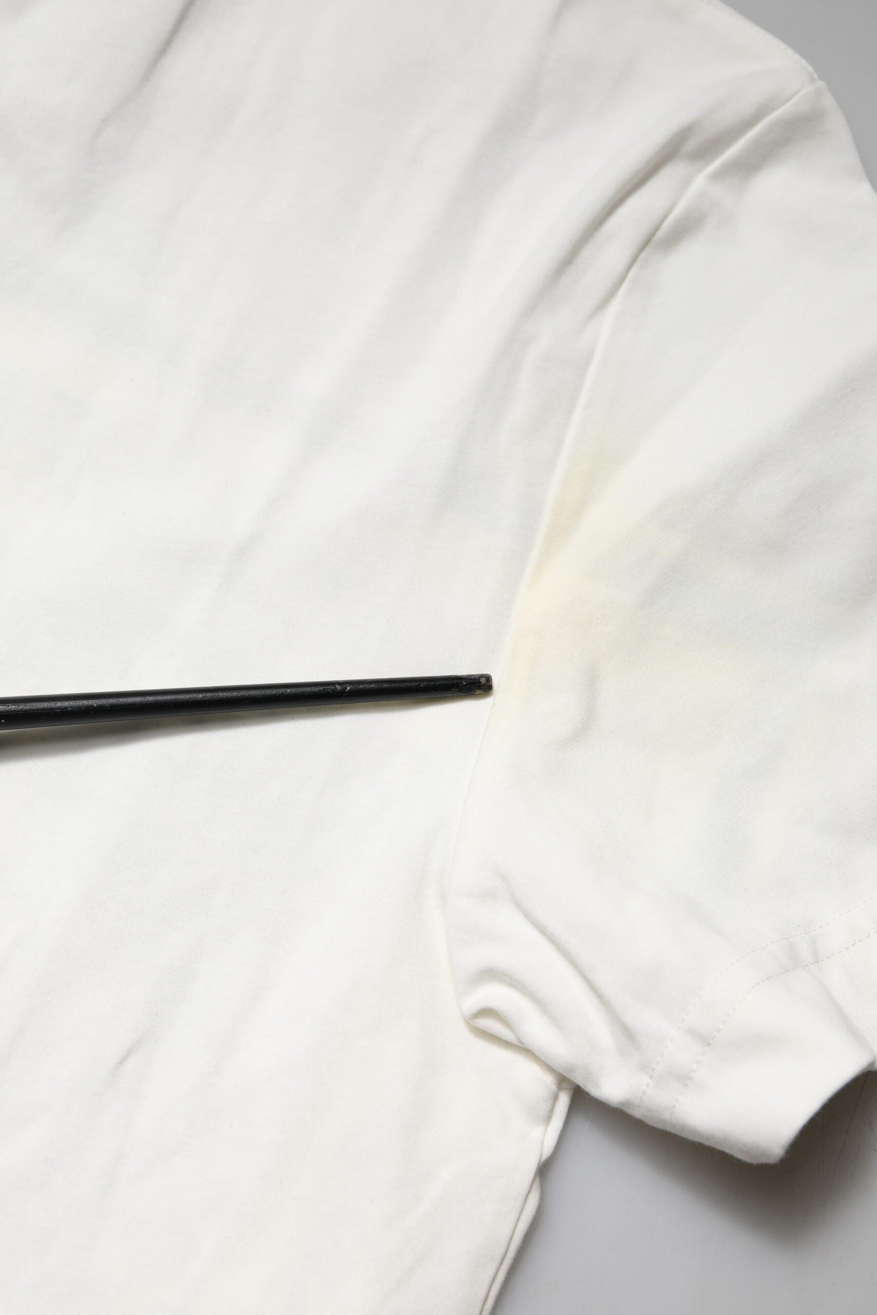 White t-shirt with black strap