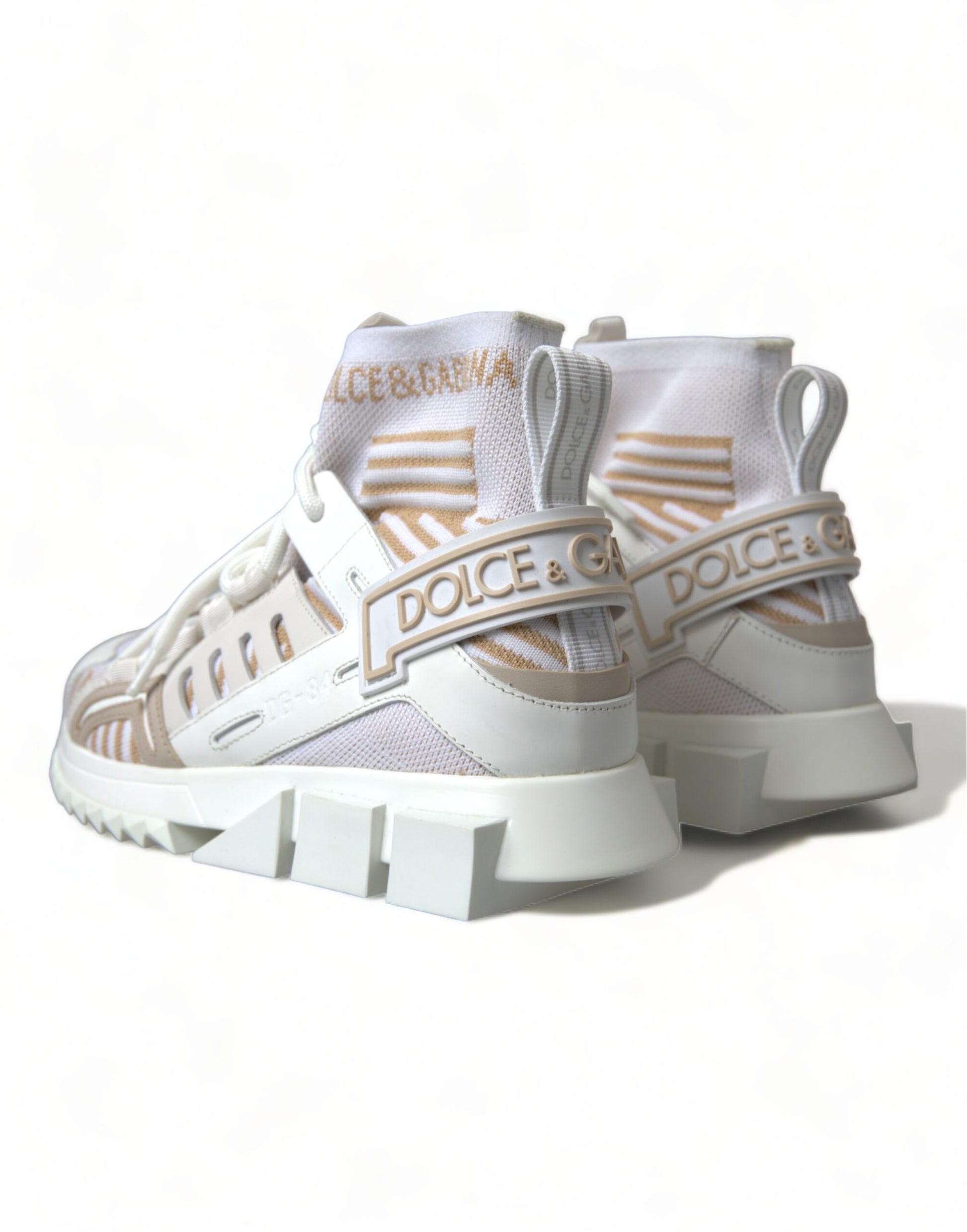 Pair of white and tan sneakers with laces and branding on side