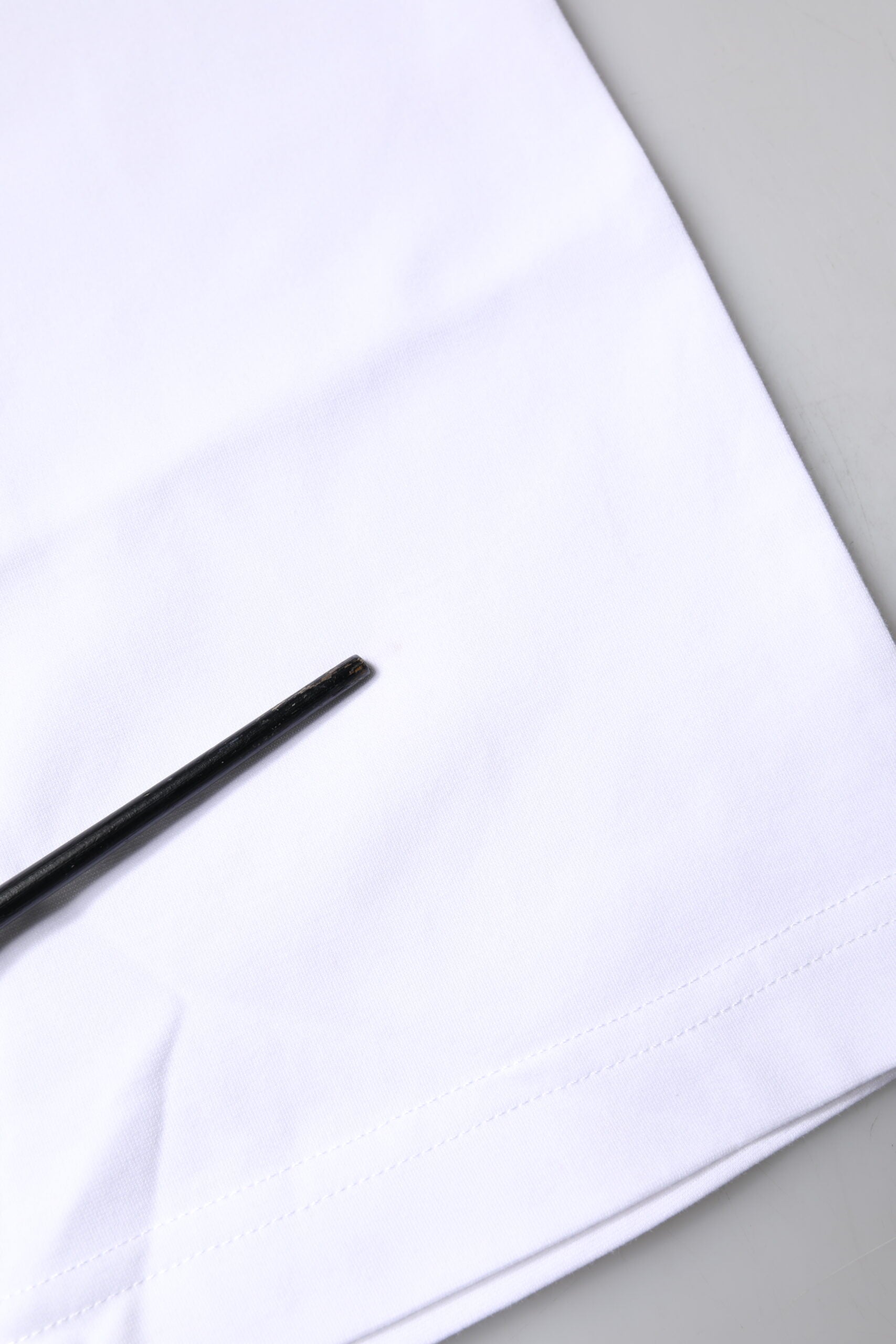Black pen on white fabric
