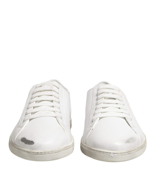 Pair of white sneakers with black laces