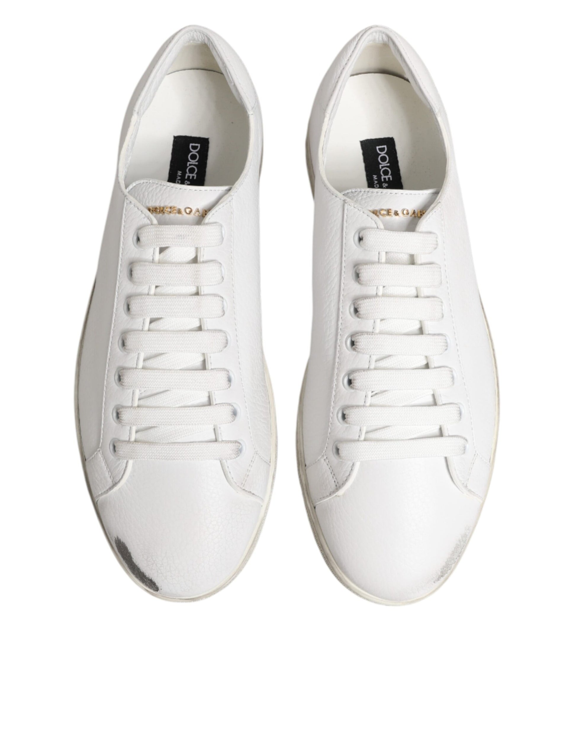 Pair of white sneakers with black laces