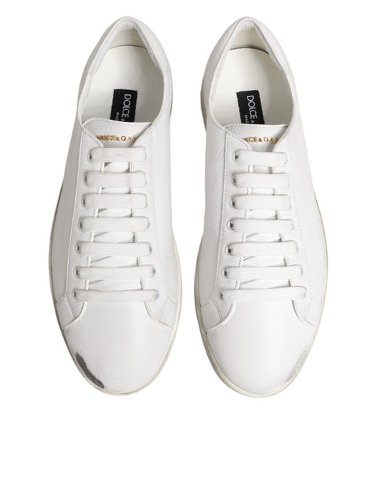 Pair of white sneakers with black laces
