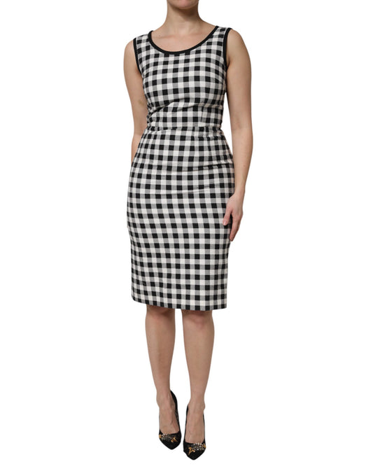 A sleeveless sheath dress with a black and white checkered pattern, designed by Dolce & Gabbana