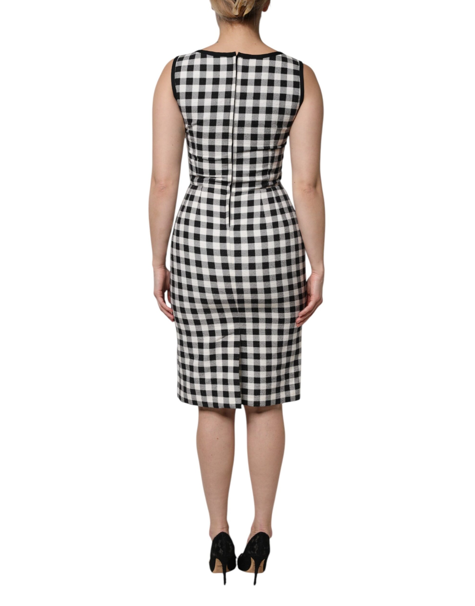 A sleeveless sheath dress with a black and white checkered pattern