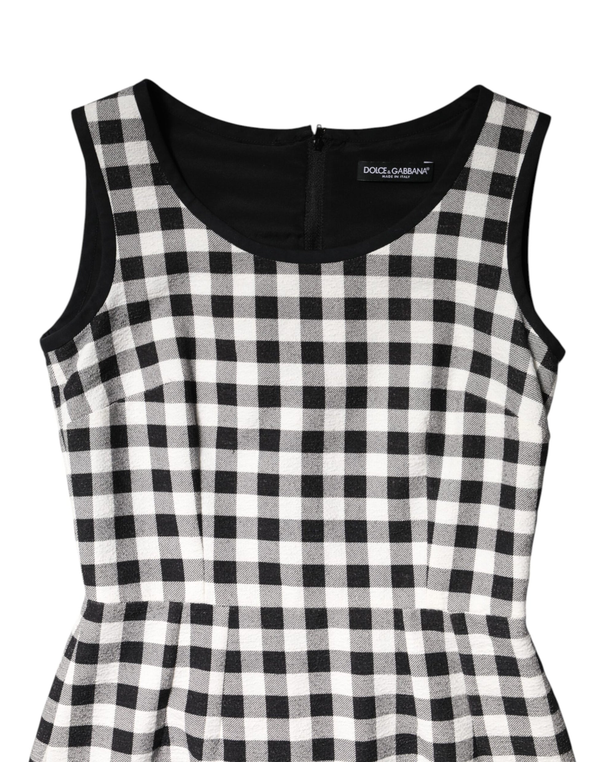 A sleeveless sheath dress with a black and white checkered pattern