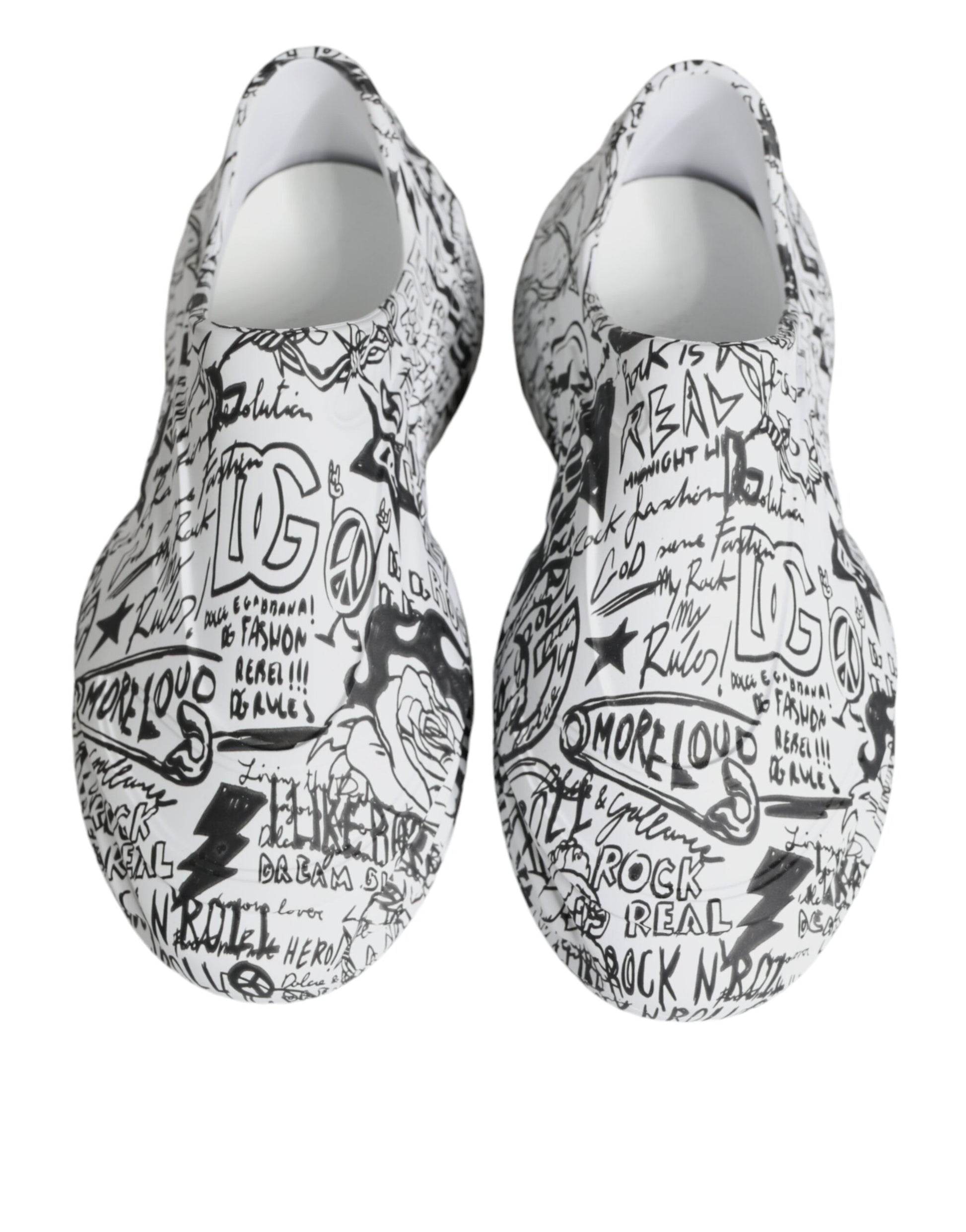 Pair of white slip on shoes with black writing and designs