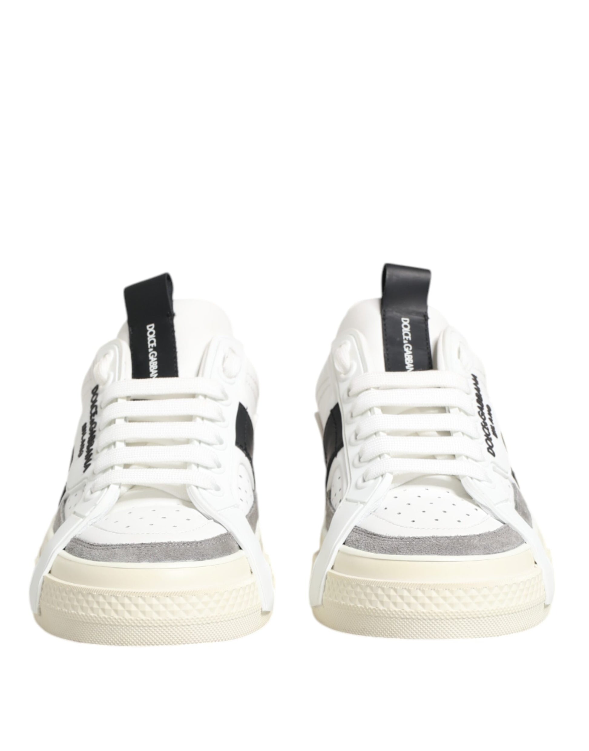 Pair of white sneakers with black laces and a black stripe on the side