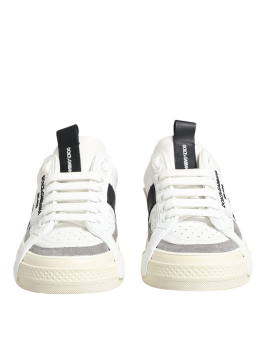 Pair of white sneakers with black laces and a black stripe on the side
