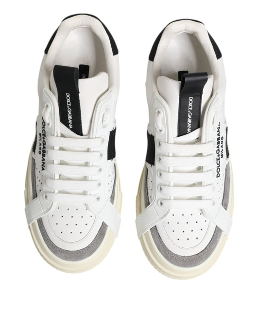Pair of white sneakers with black stripe on side