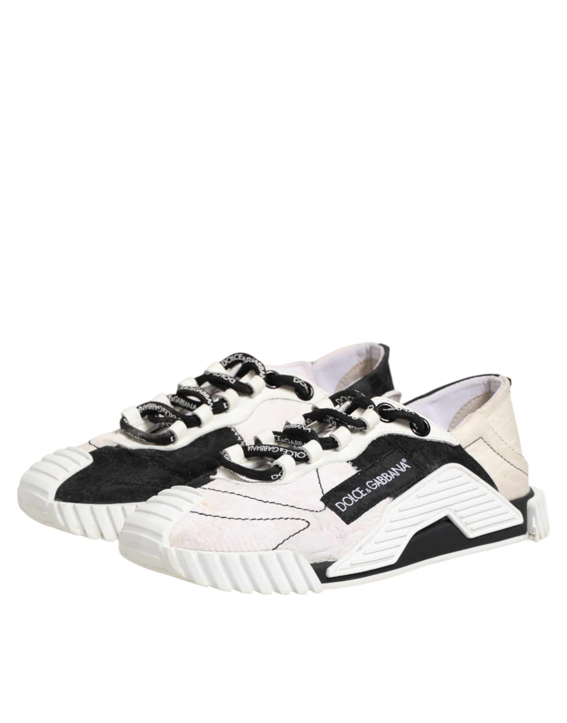 A pair of black and white leather sneakers with laces, featuring a logo on the side