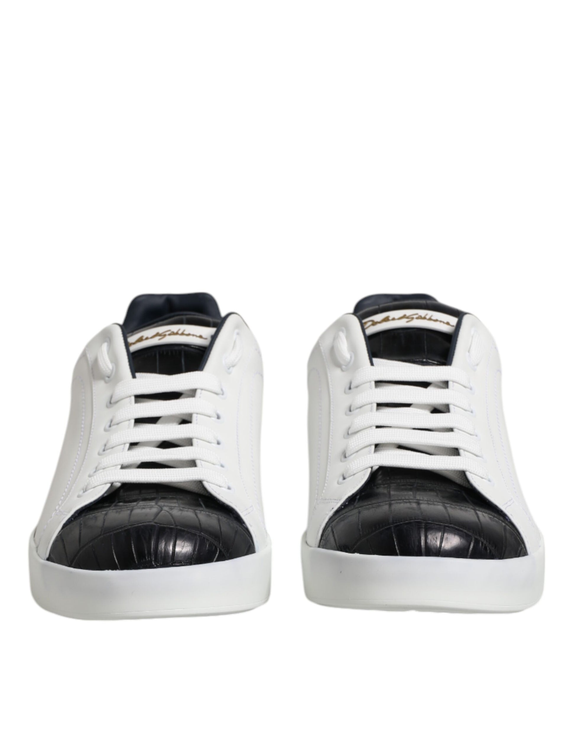 Pair of white black leather sneakers with gold accents, featuring a crocodile skin texture on the toe and heel