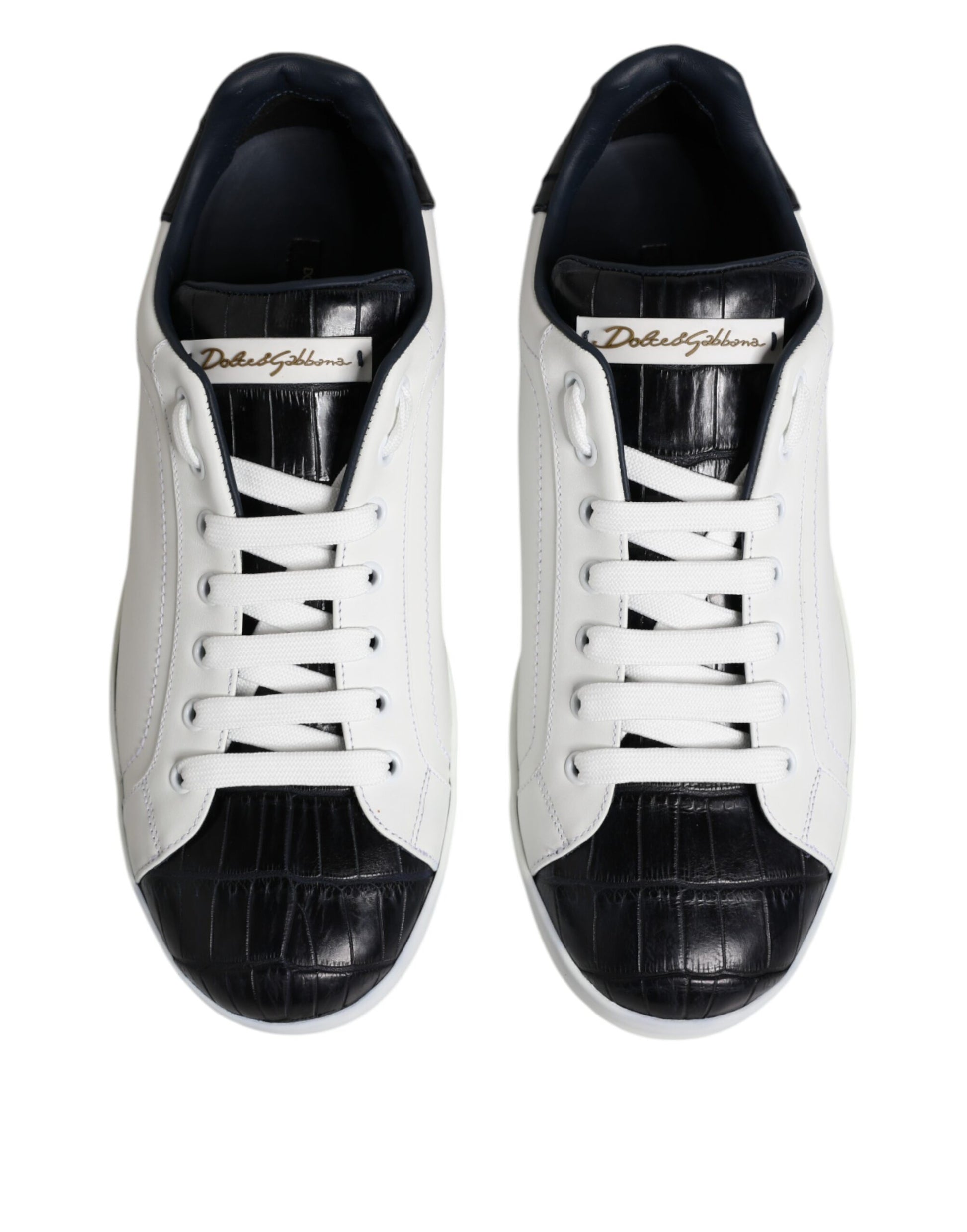 Pair of white black leather sneakers with gold logo, featuring laces and a round toe
