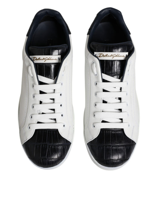 Pair of white black leather sneakers with gold logo, featuring laces and a round toe