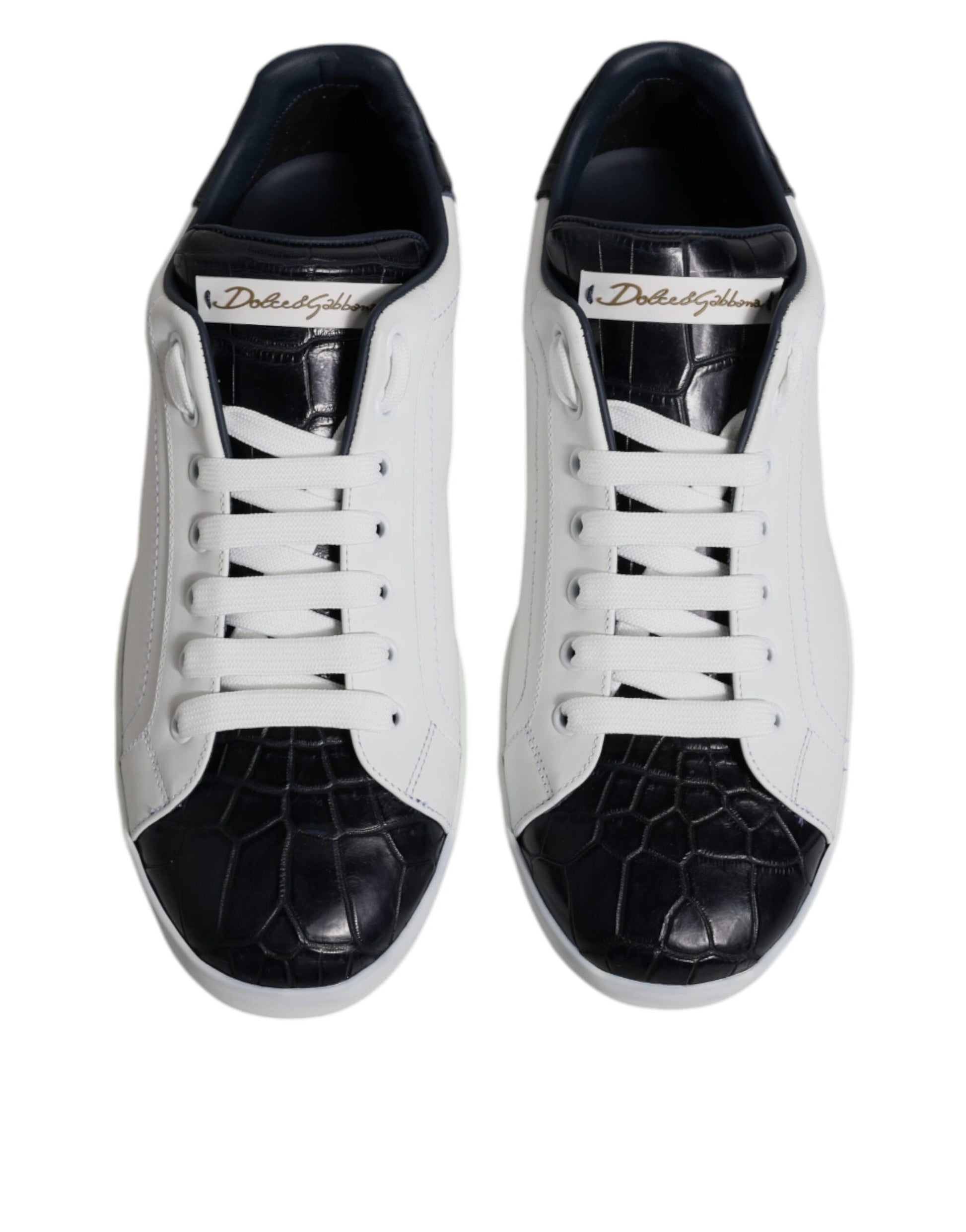 Pair of black and white leather sneakers with a crocodile skin texture on the toe