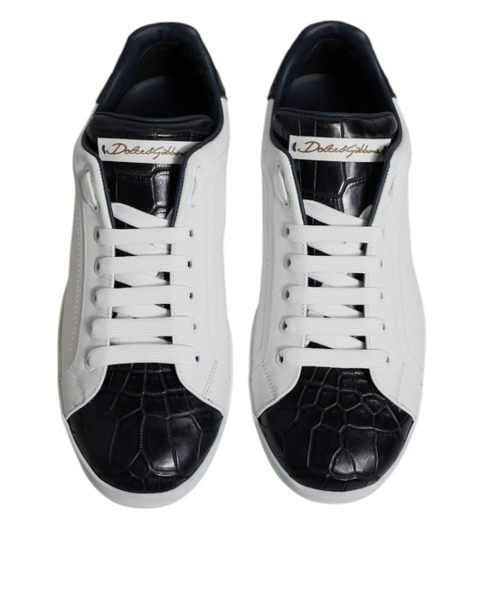 Pair of black and white leather sneakers with a crocodile skin texture on the toe