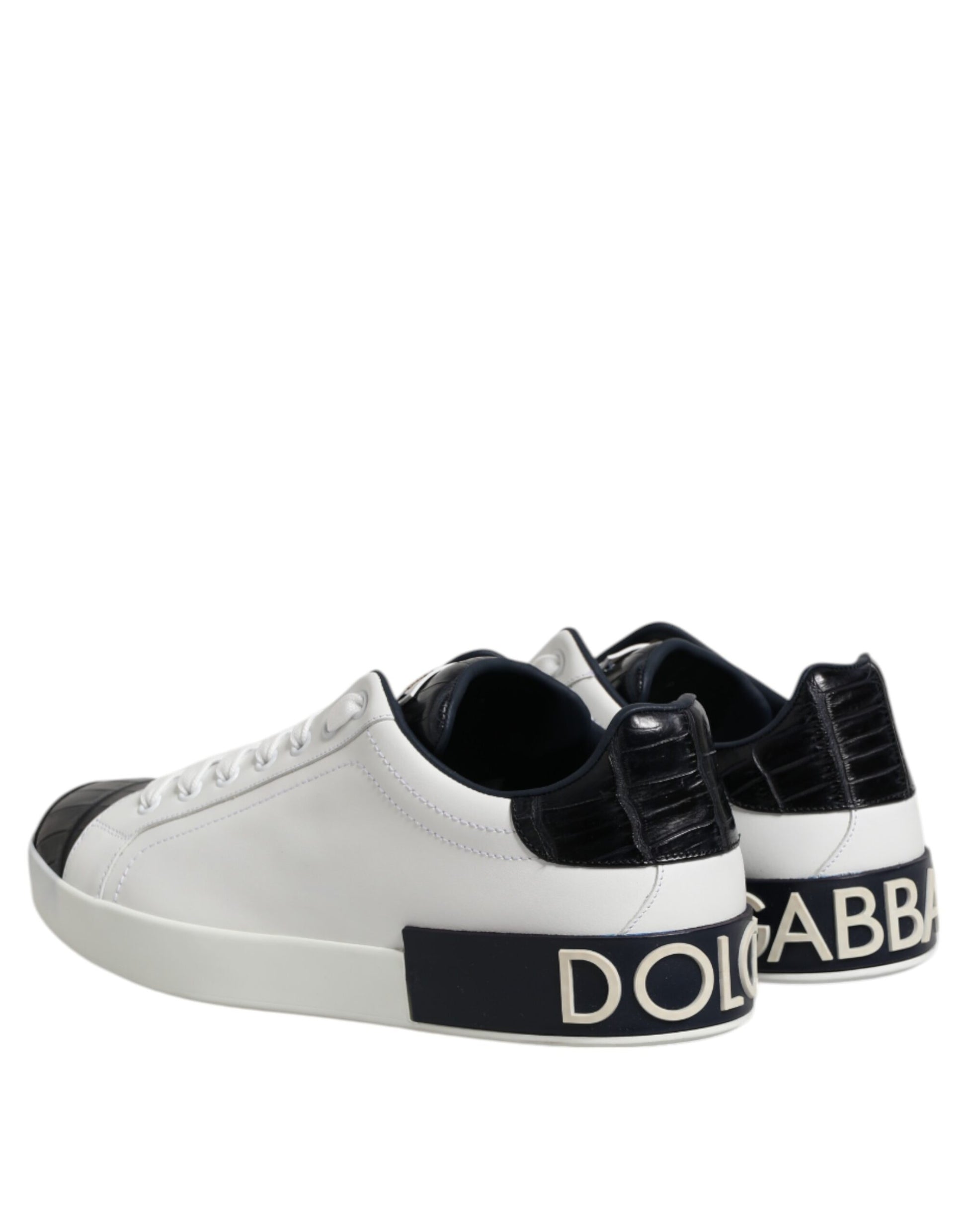 A pair of white black leather sneakers with a branded logo on the side, featuring a lace-up design and a chunky sole