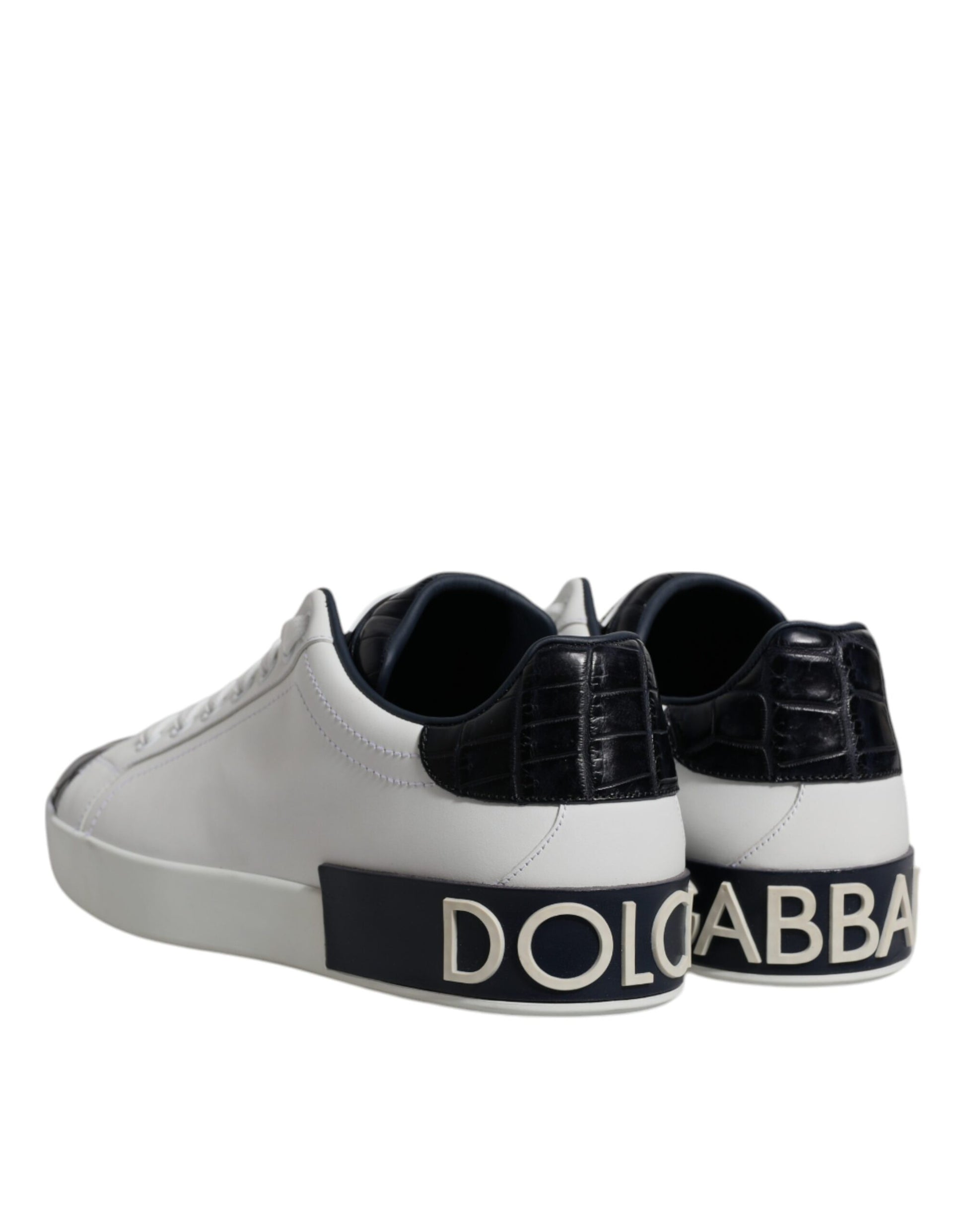 Pair of white black leather sneakers with brand name on side