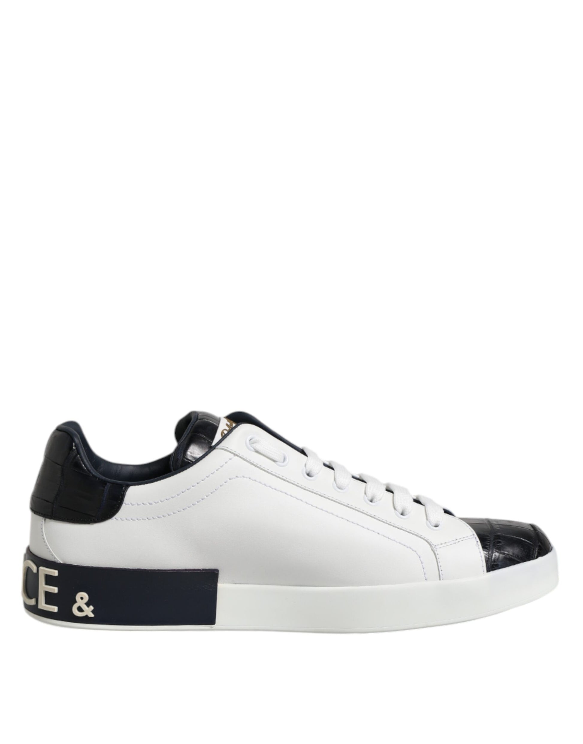 A pair of white black leather sneakers with a gold logo on the side, featuring a low top and laces