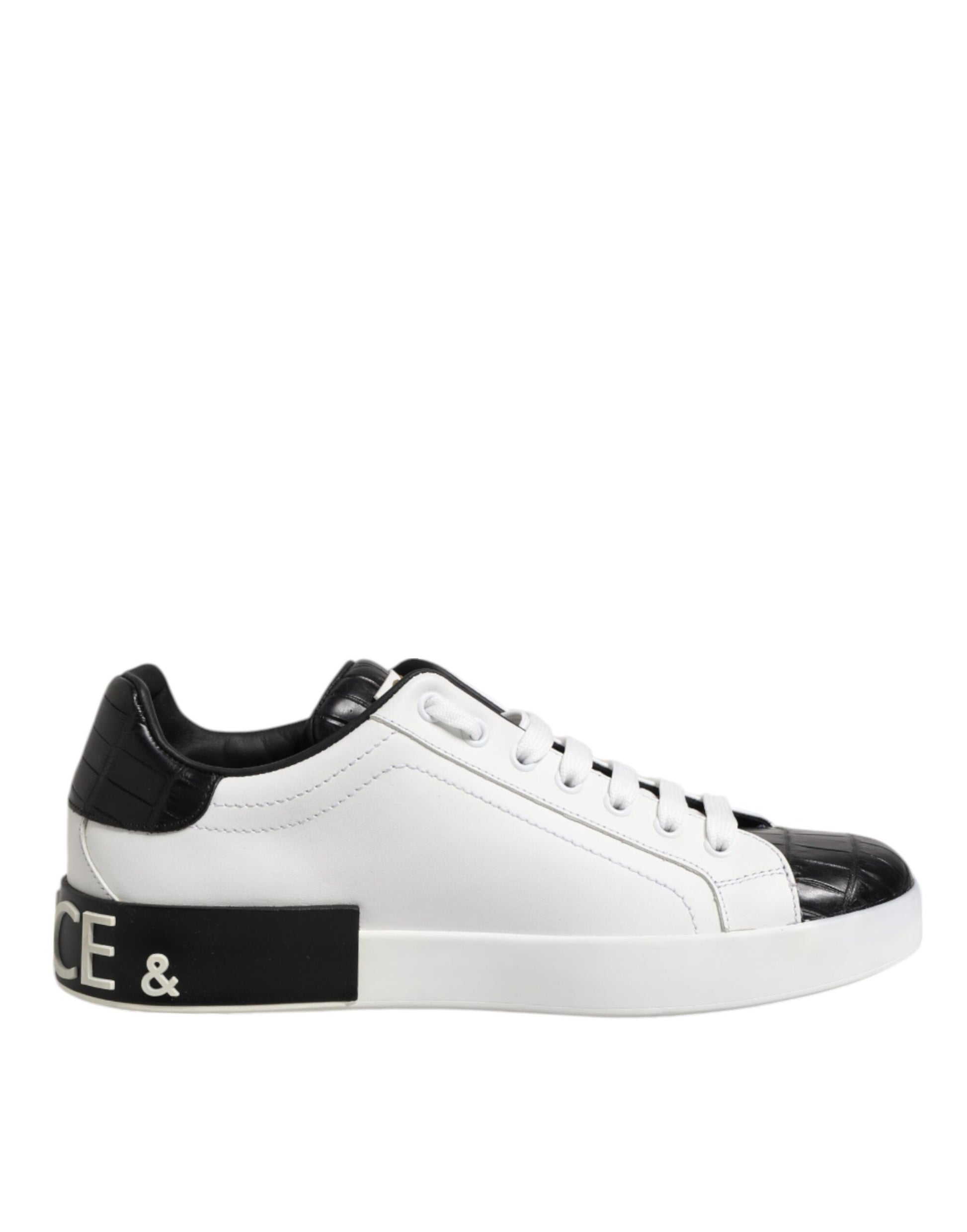A pair of white black leather sneakers with a logo on the side, featuring a lace-up design and a chunky sole