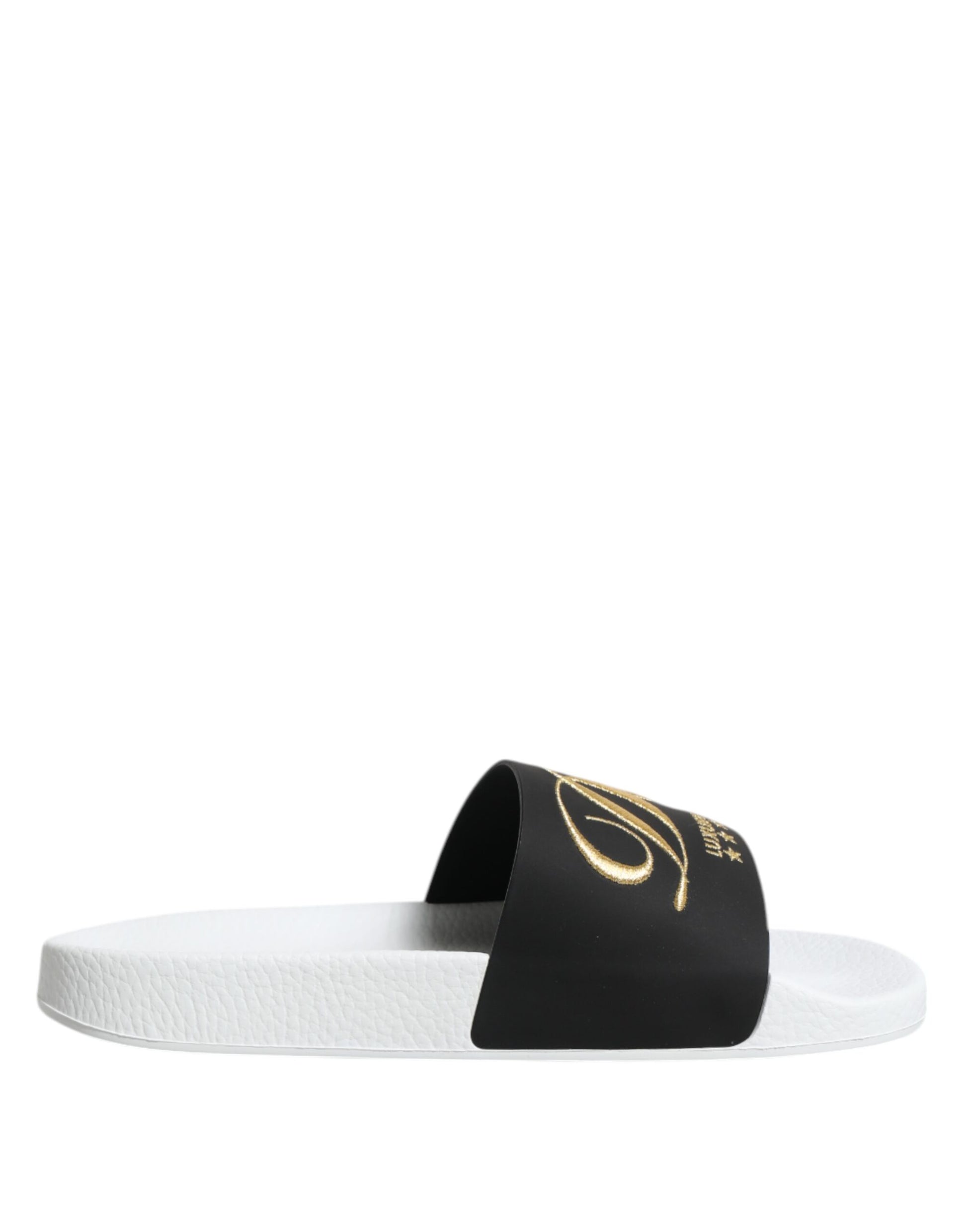 Pair of white flip flops with black trim and gold lettering on straps