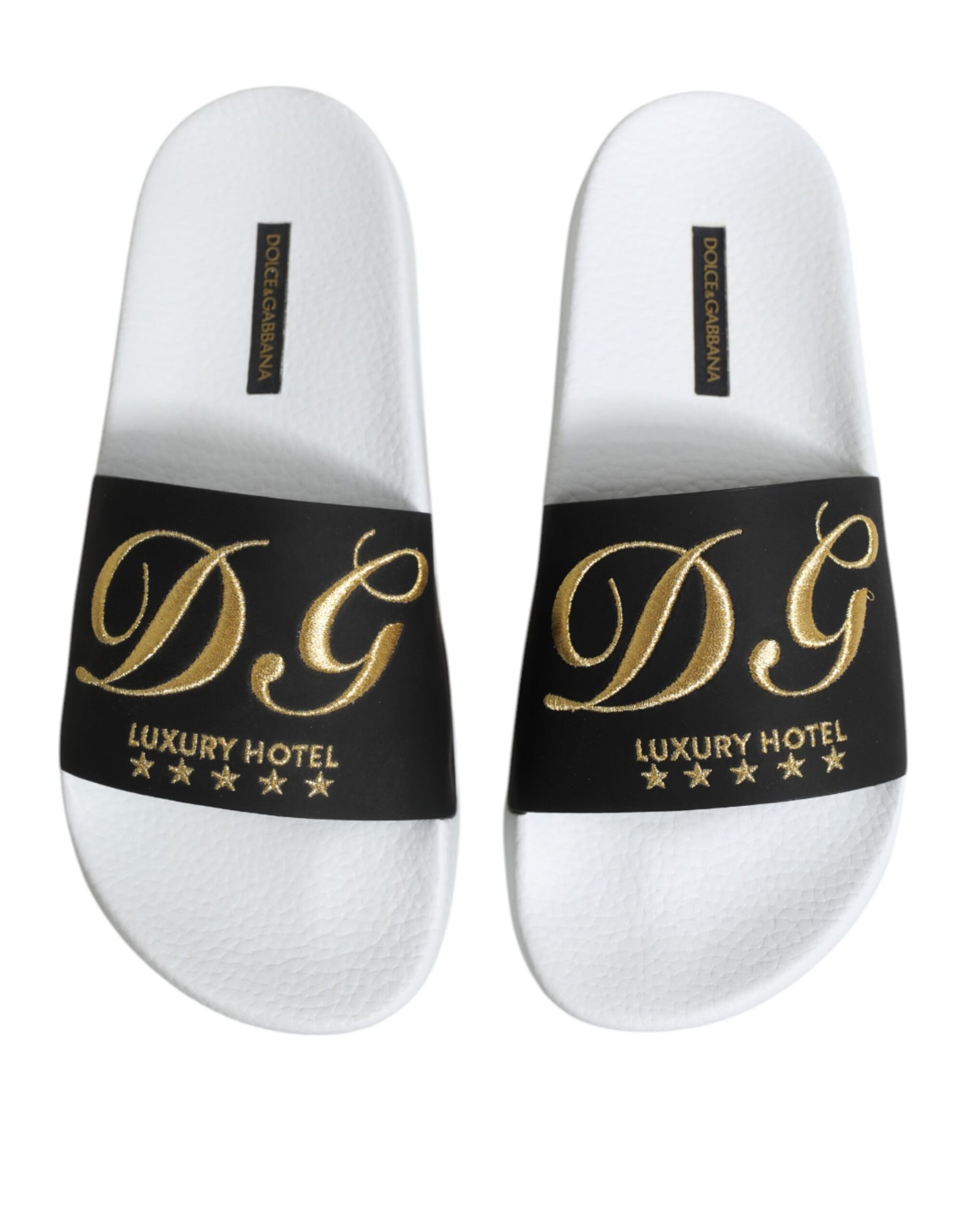 Pair of white slippers with black lettering and stars