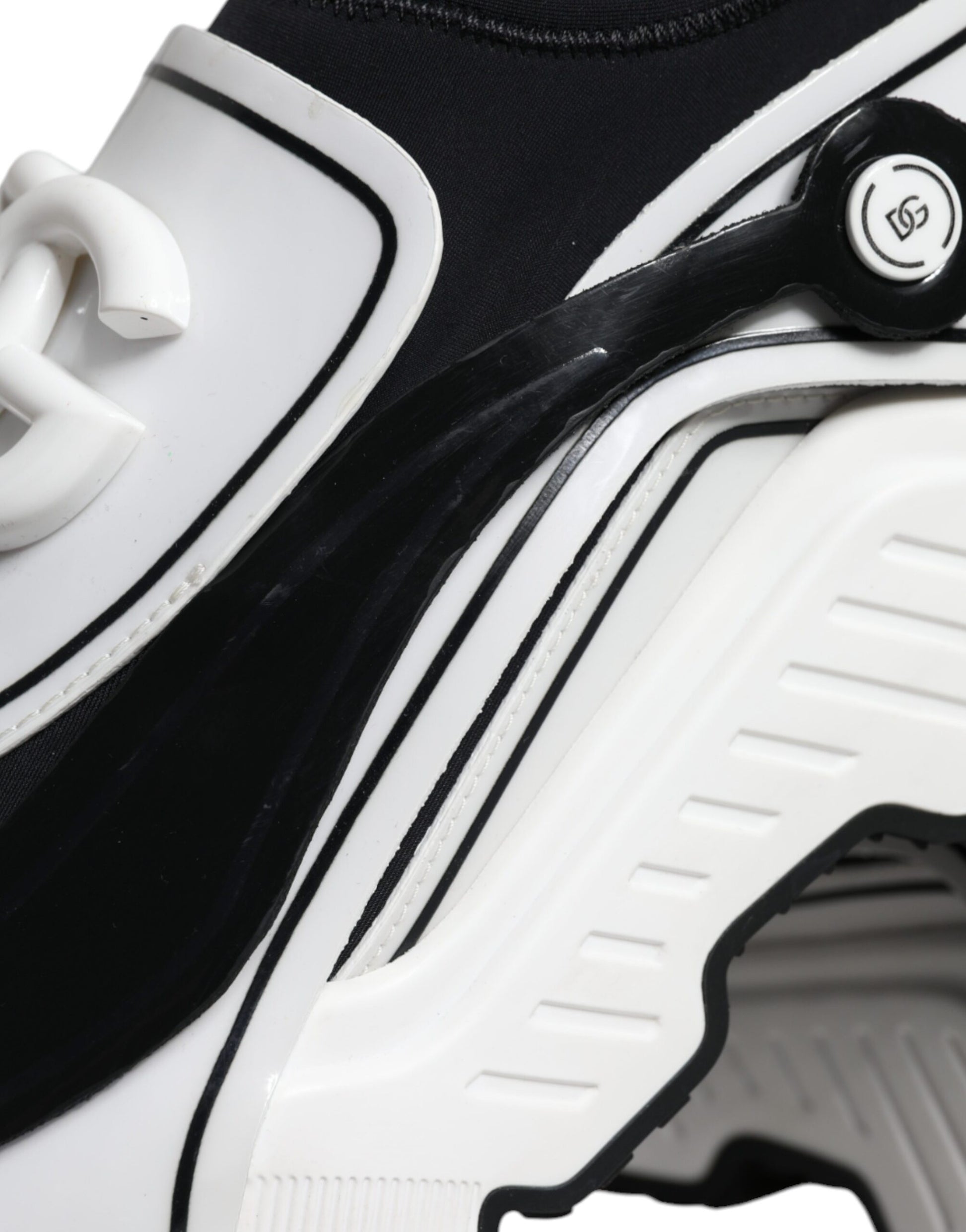 Black and white athletic shoe with laces and a pull tab on the heel