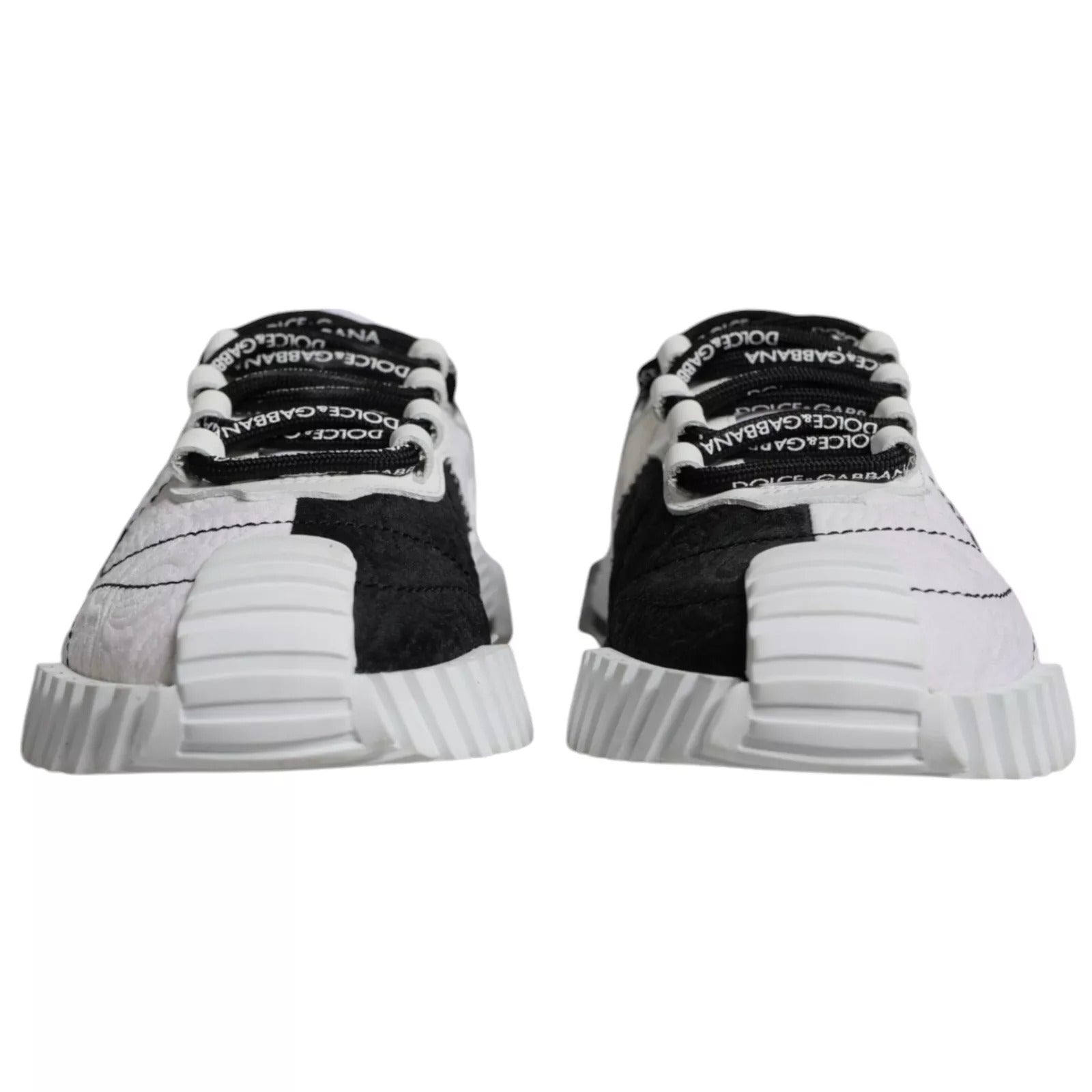 Pair of sneakers with white soles and black laces