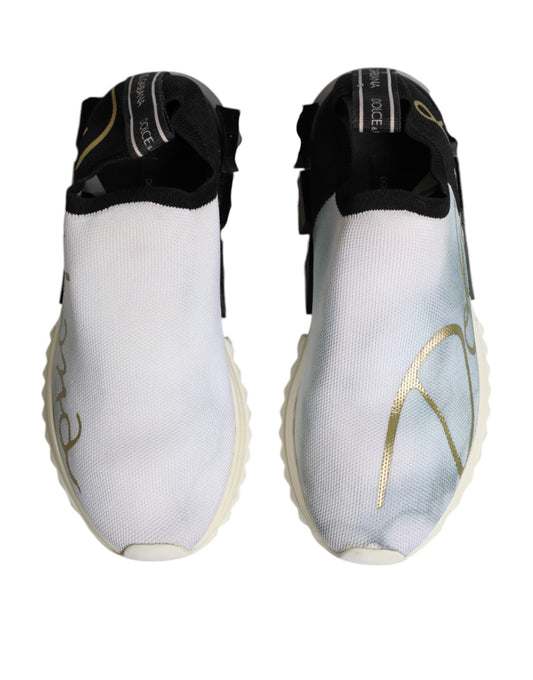 Pair of white, black, and gold sneakers with laces