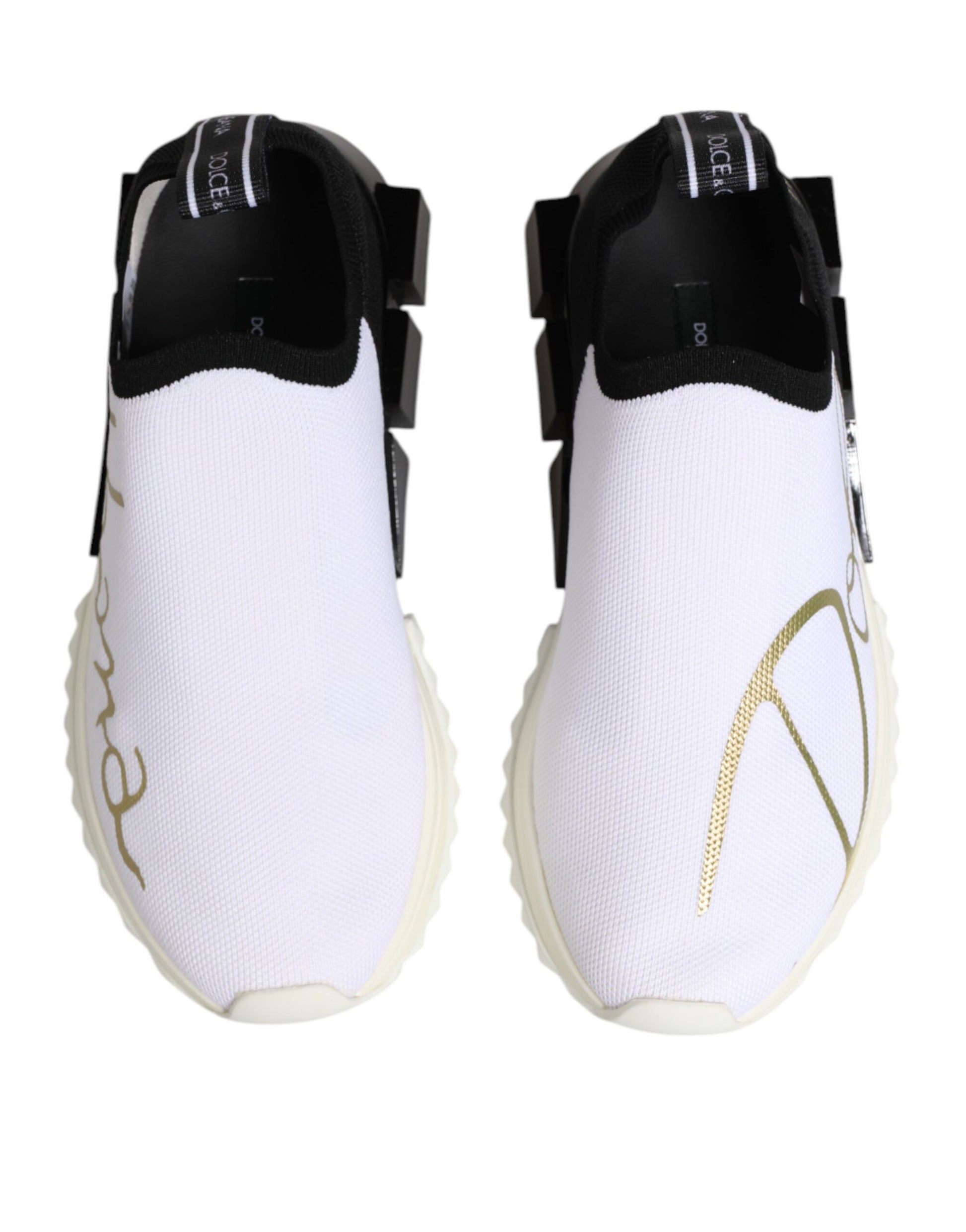Pair of white sneakers with black straps and gold lettering