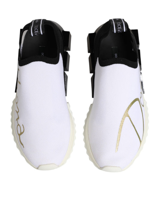 Pair of white sneakers with black straps and gold lettering
