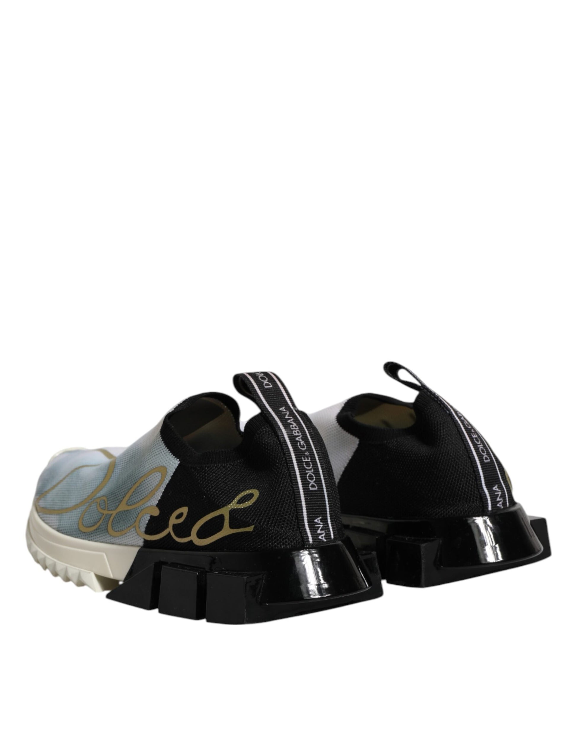 Pair of white, black, and gold slip-on shoes with brand name on side