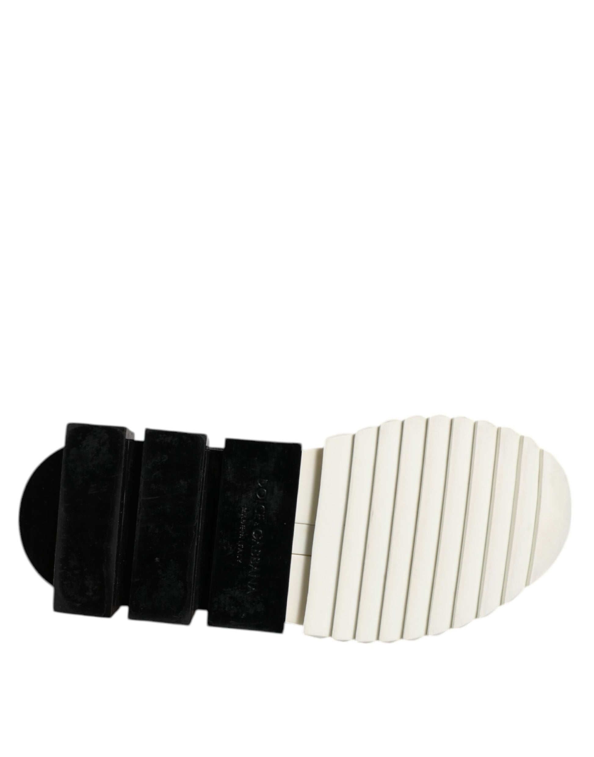 A pair of black and white sneakers with a low top design, featuring the Dolce & Gabbana logo