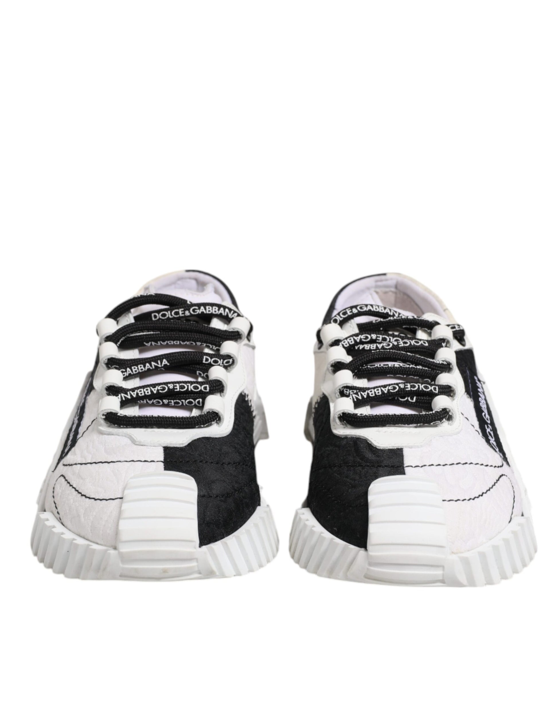 Pair of children's sneakers with white soles and black laces