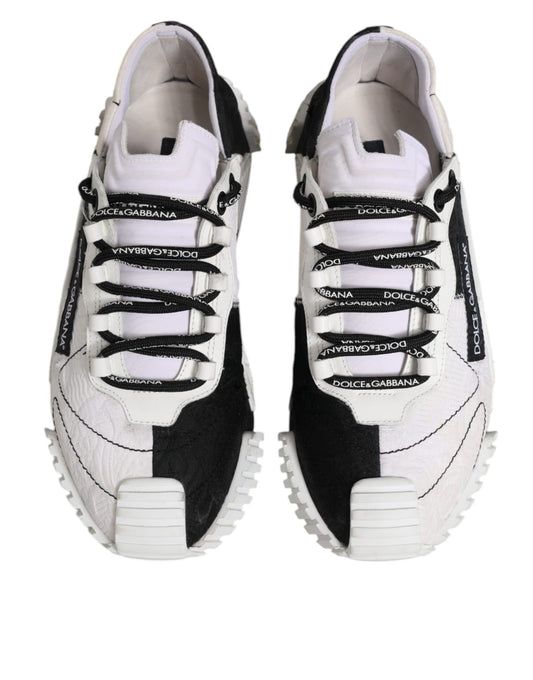 Pair of white sneakers with black laces and soles