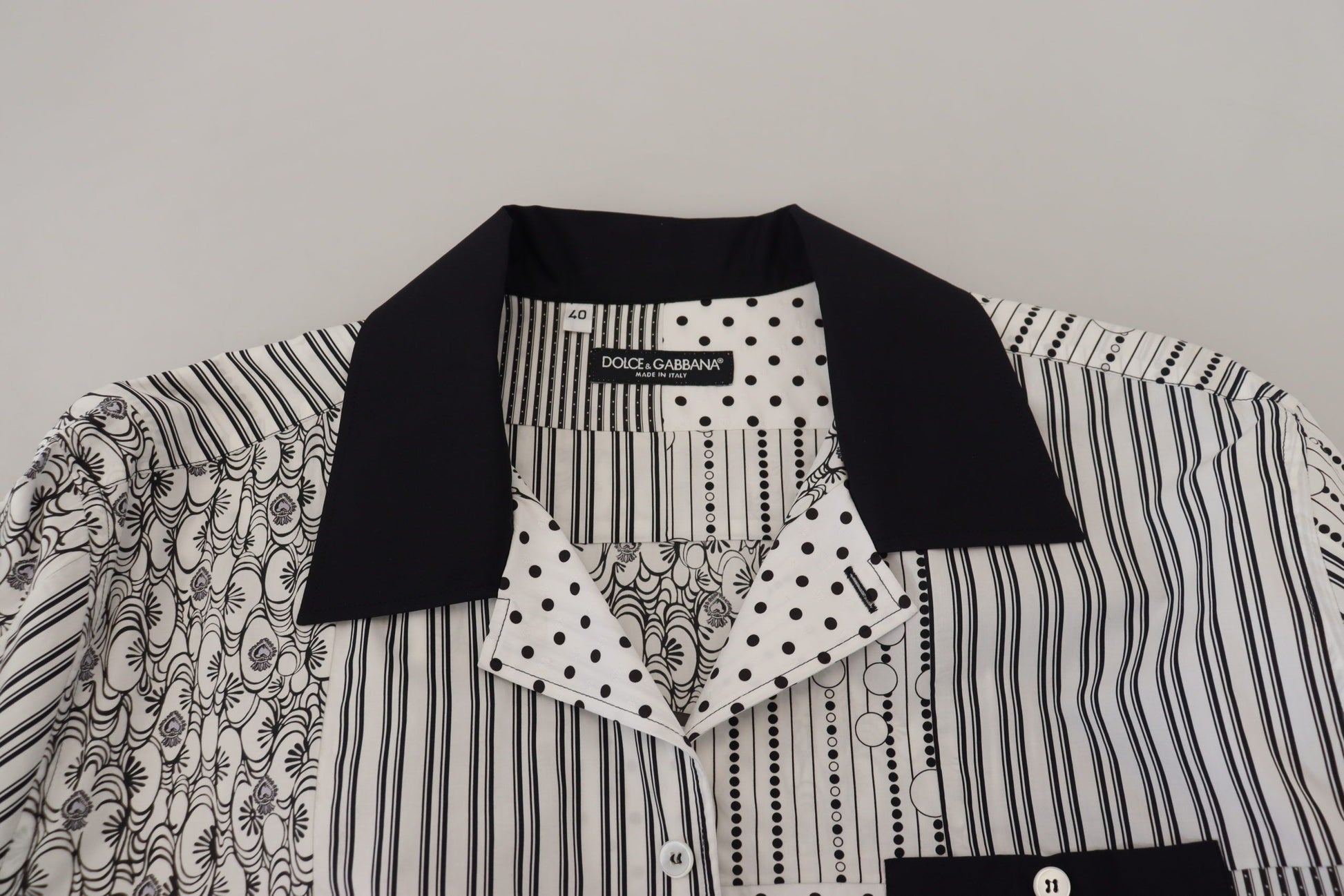 Black and white patterned shirt with a scarf around neck