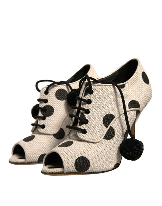 White polka dot high heel shoes with black laces and a bow on top