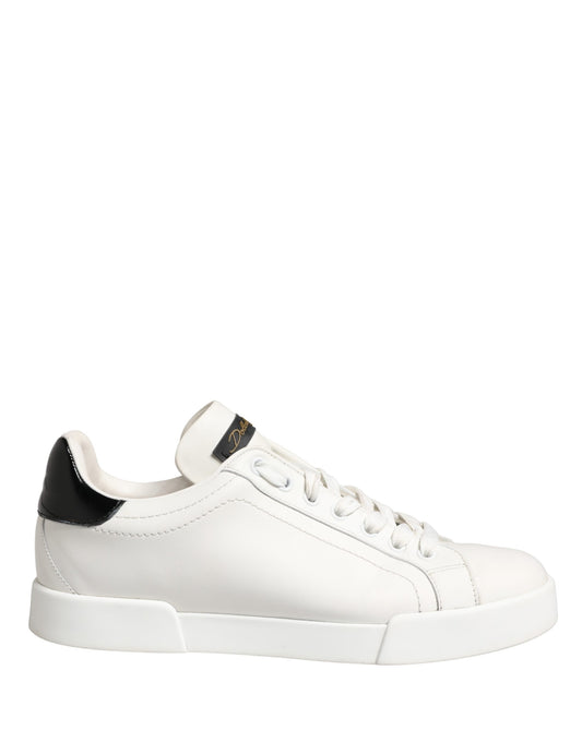 White leather sneakers with black accents, featuring a low-top design and laces