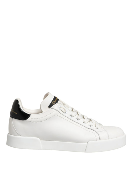 White black leather sneakers with gold accents, featuring a low-top design and lace closure