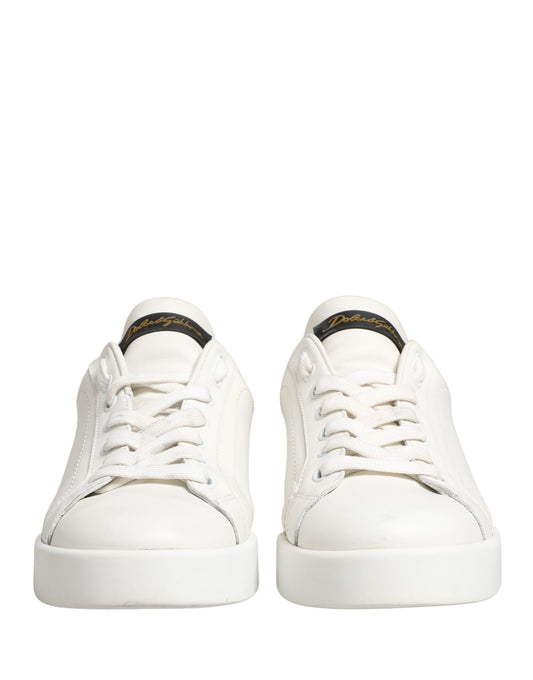 Pair of white sneakers with black accents and a gold logo on the side