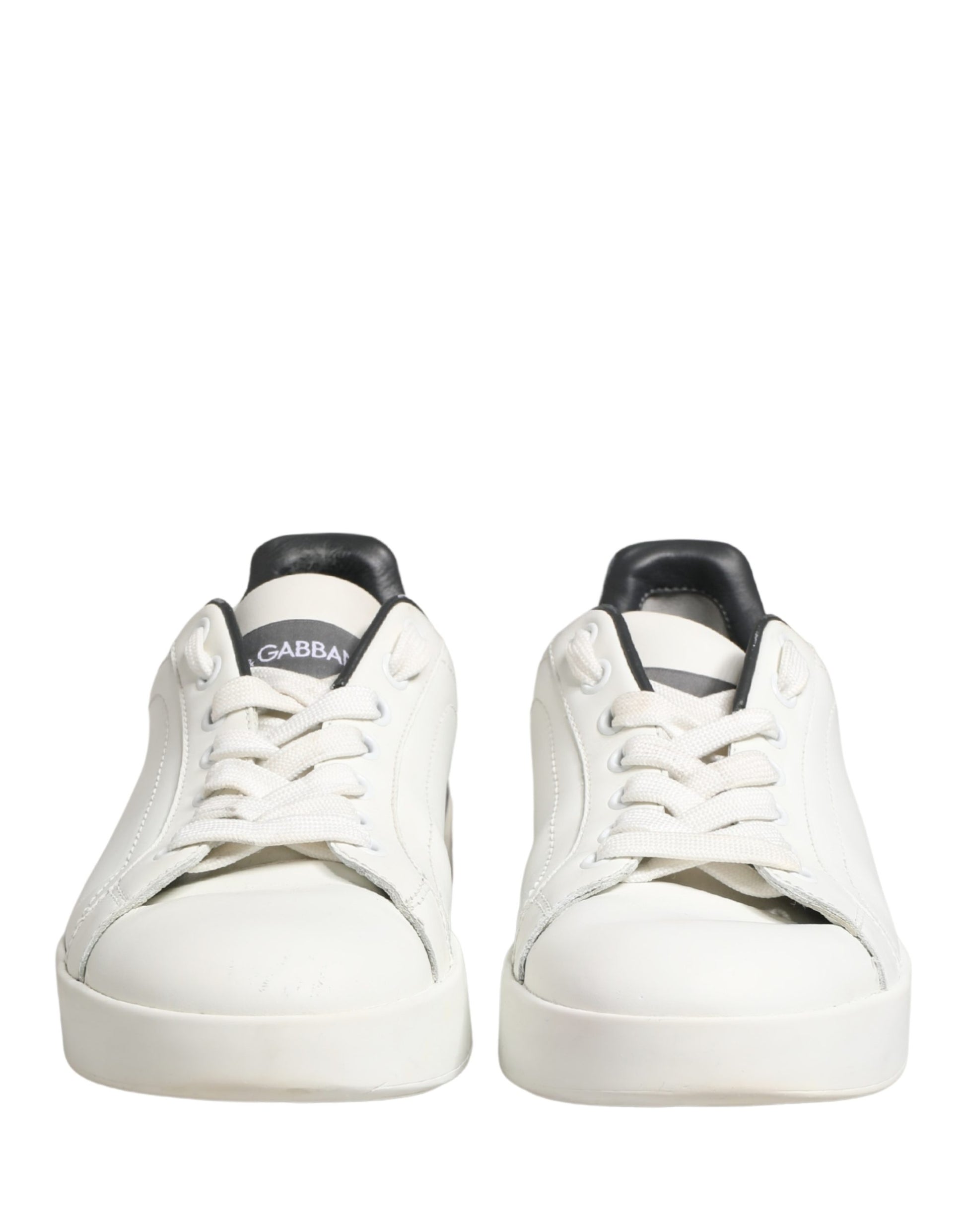 Pair of white and black leather sneakers with laces, branded logo on side