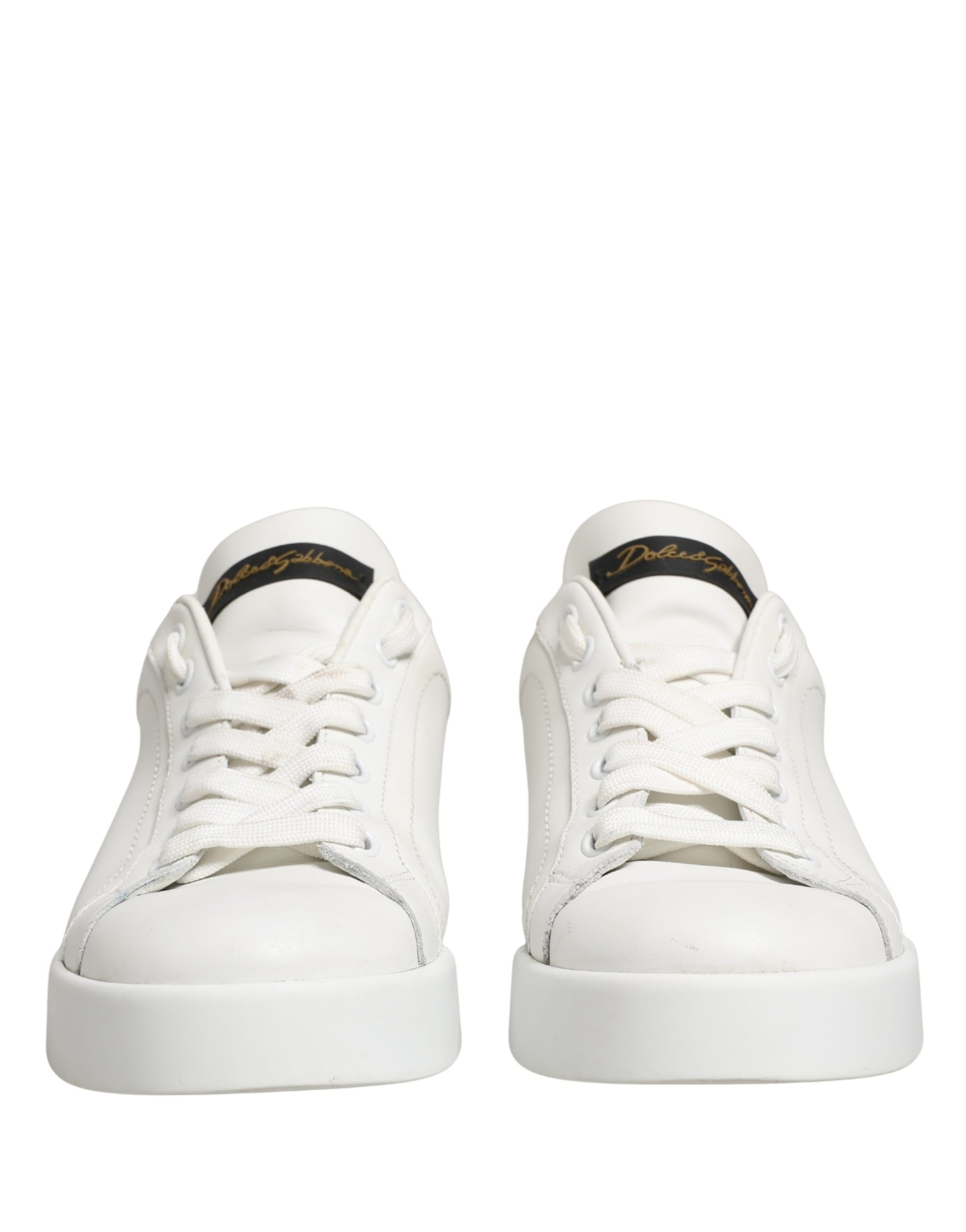 Pair of white leather sneakers with black accents, featuring a low-top design and lace closure