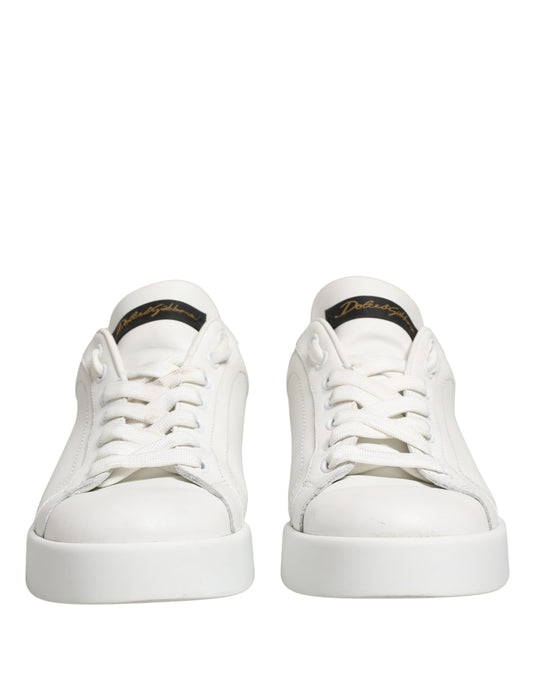 Pair of white leather sneakers with black accents, featuring a low-top design and lace closure