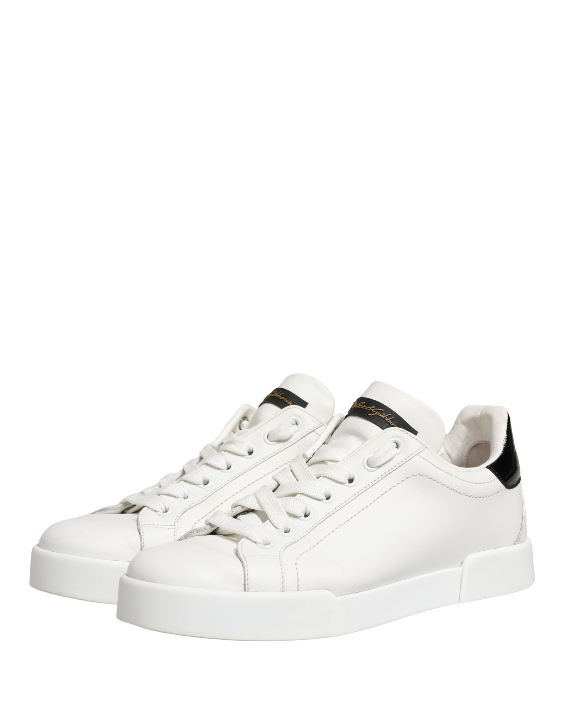 White leather sneakers with black accents, featuring a low-top design and chunky sole