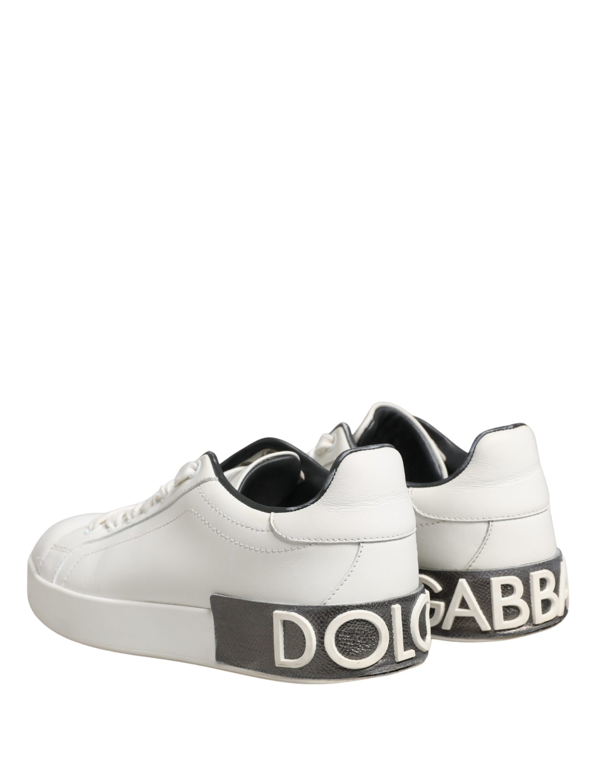 White leather sneakers with black accents, featuring a prominent logo on the side