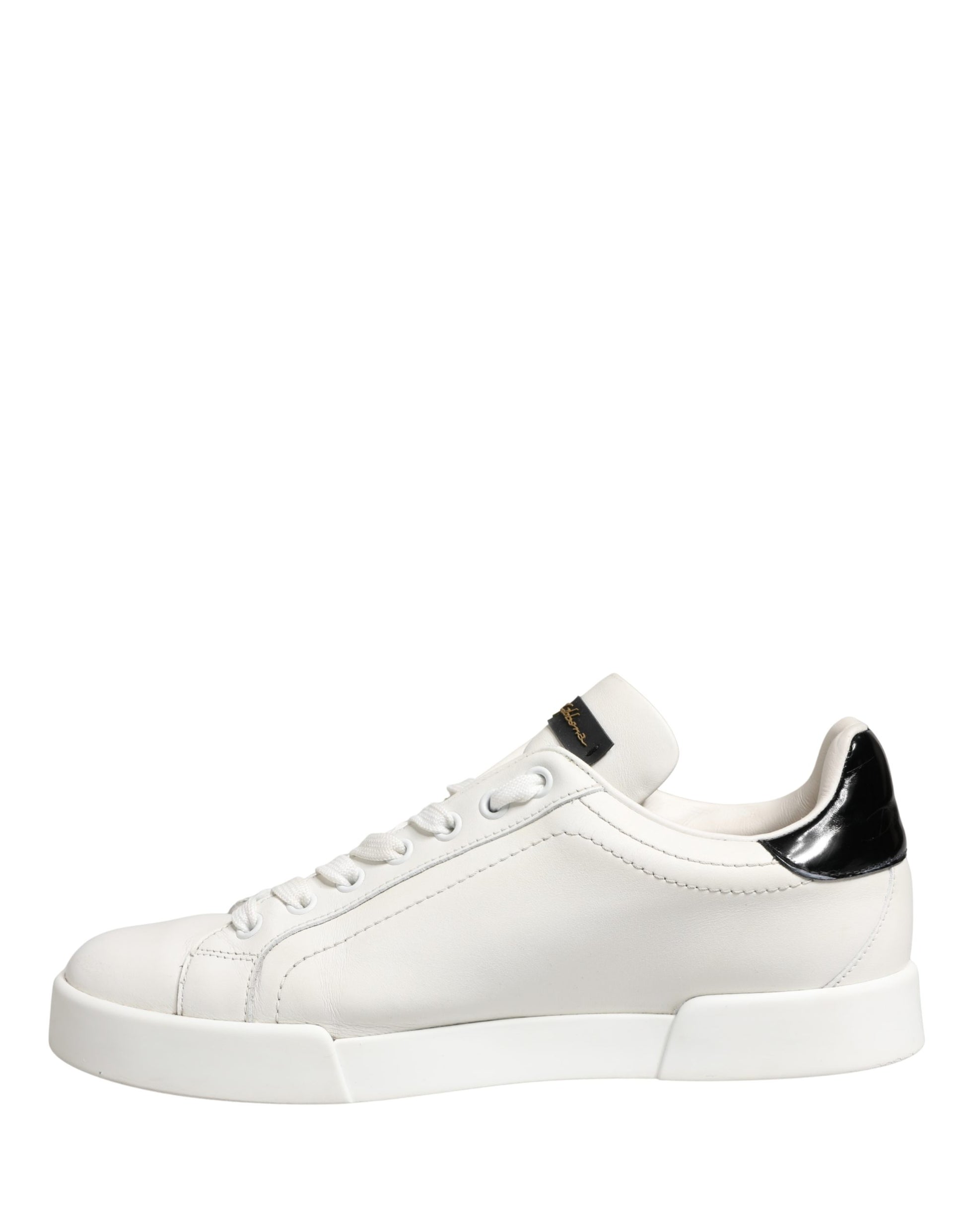 White black leather sneakers with gold accents, featuring a low-top design and laces
