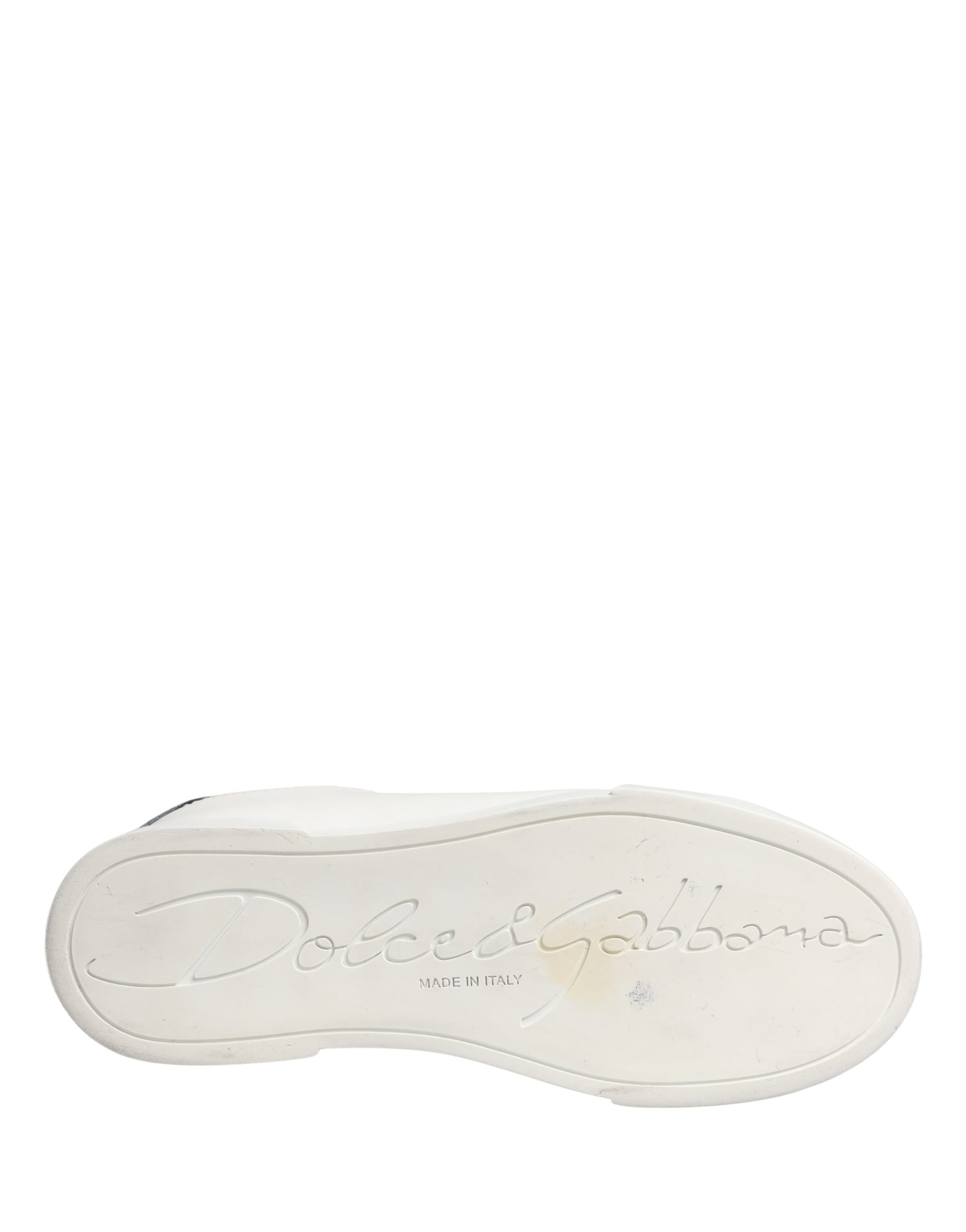 A single white and black leather sneaker with a logo on the side, likely from the brand Dolce & Gabbana