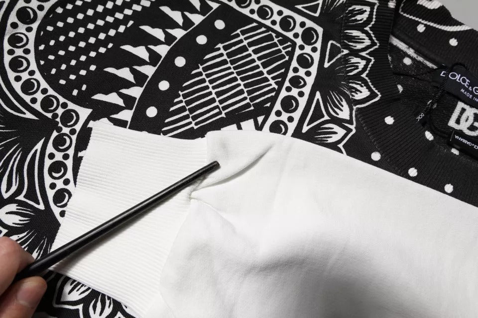 Hand holding a black and white patterned cloth napkin