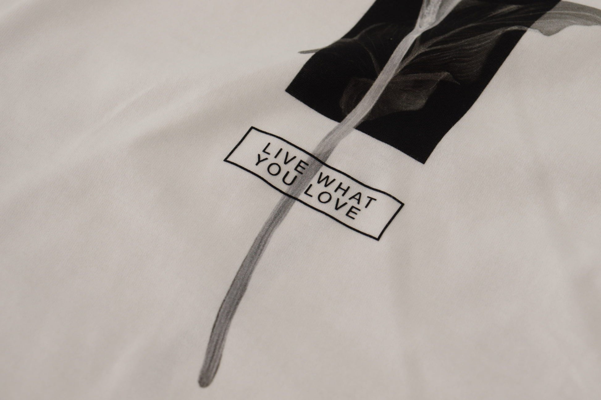 White t-shirt with black text and graphic